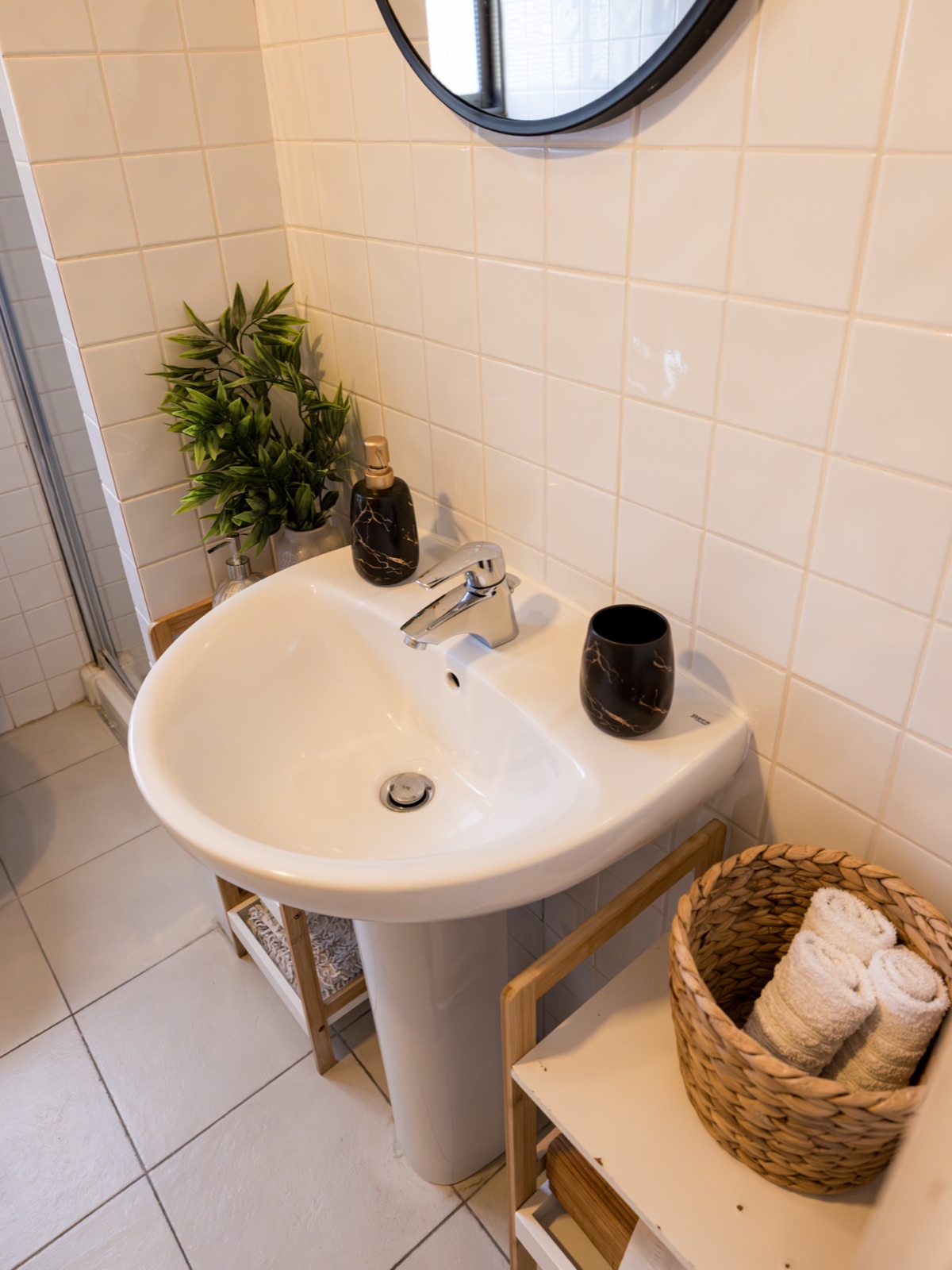 Bathroom sink with plants and marble accessories